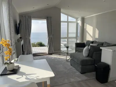 a living room with a couch and a table at Sea Breeze Lodge in Aberaeron