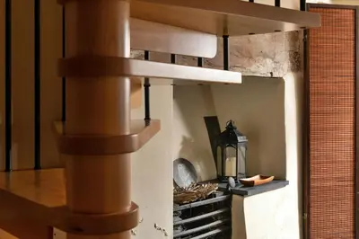 a spiral staircase in a kitchen with a pizza oven at Finest Retreats - Dolwar Cottage in Ffestiniog