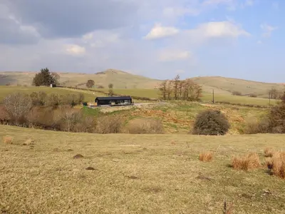 a train on a track in a field of grass at The Sheep Shed in Oswestry