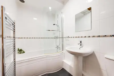 a white bathroom with a sink and a shower at 2 Bed in Dolgellau oc-bow282 in Trawsfynydd