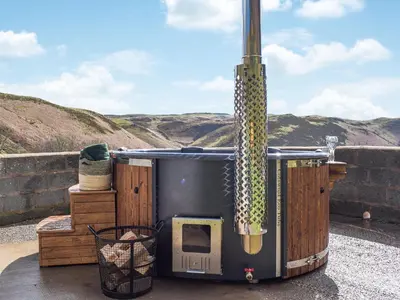a large outdoor hot tub sitting on a patio at Blaen Y Cwm in Carno