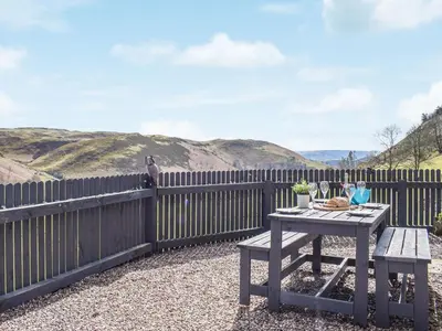 a picnic table on the side of a fence at Blaen Y Cwm in Carno