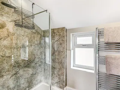 a bathroom with a shower and a window at Upper Bryn Y Groes in New Bridge
