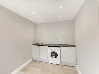 a laundry room with a washer and dryer at Upper Bryn Y Groes in New Bridge