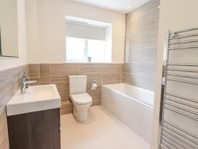 a bathroom with a toilet and a sink and a bath tub at Mawnog Fach in Bala