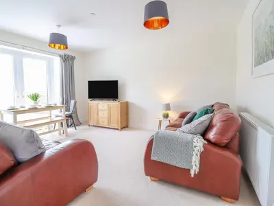 a living room with a couch and a television at Mawnog Fach in Bala