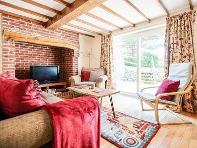a living room with a couch and a tv at Morannedd Bach in Dyffryn