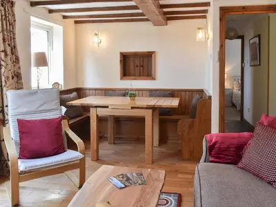 a living room with a table and a couch at Morannedd Bach in Dyffryn