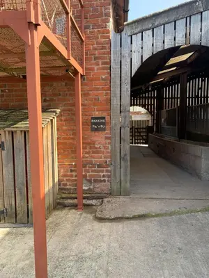 a brick building with a sign on the side of it at The Pig and Sty in Hereford