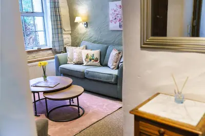 a living room with a couch and a table at Brynarth Country Cottages in Aberystwyth