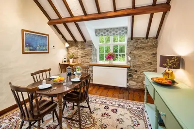 a kitchen and dining room with a table and chairs at Brynarth Country Cottages in Aberystwyth
