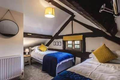 a bedroom with two beds in a attic at River Cottage, Melverley in Melverley