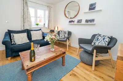 a living room with a couch and a table at Modern and bright 2-bed home near Ludlow centre - Pass the Keys in Ludlow