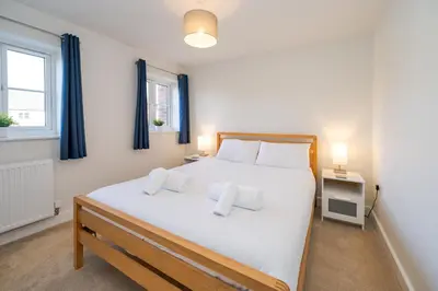 a bedroom with a large white bed with two pillows at Modern and bright 2-bed home near Ludlow centre - Pass the Keys in Ludlow