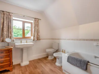 a bathroom with a toilet and a sink and a tub at Cwmfron House in Llanidloes