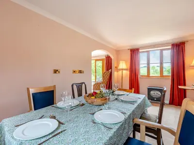 a dining room with a table with plates and wine glasses at Cwmfron House in Llanidloes