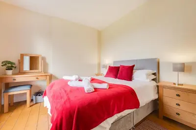 a bedroom with a large bed with towels on it at 5 Bed in Llandovery oc-bow323 in Llangadog