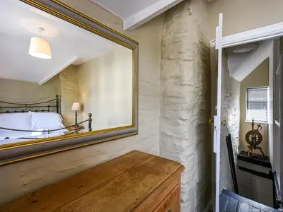 a bedroom with a large mirror on the wall at Bwthyn Llys Machynlleth Old Court House in Machynlleth