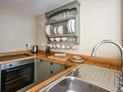 a kitchen with a sink and a counter at Bwthyn Llys Machynlleth Old Court House in Machynlleth