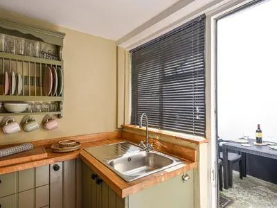 a kitchen with a sink and a window at Bwthyn Llys Machynlleth Old Court House in Machynlleth