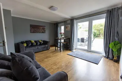 a living room with a couch and a sliding glass door at Cul-de-sac Creations in Shrewsbury