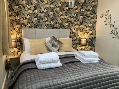 a bedroom with a bed with towels on it at Rooftops - bijou sister apartment to Assembly View - free parking permit provided in Ludlow