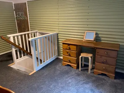 a room with a desk and a staircase with a laptop on it at Hay View Lodges - Barn End in Hay-on-Wye
