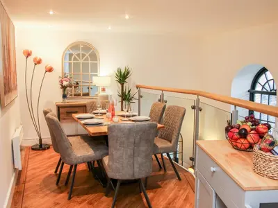 a dining room with a table and chairs at 6 The Engine Shed in Shrewsbury