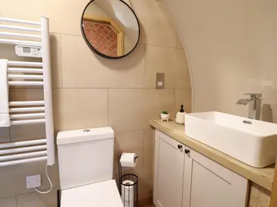 a bathroom with a white toilet and a sink at Nant yr Esgair in Machynlleth