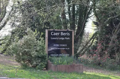 a sign for a car park in a field at HEDDFAN, Luxury 3 bedroom timber lodge, Now with WiFi, Caer Beris Holiday Park, Builth Wells, SORRY NO TRADESMEN OR CONTRACTORS ALLOWED in Builth Wells
