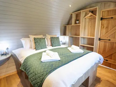 a bedroom with a bed with towels on it at Nant y Garnedd in Machynlleth