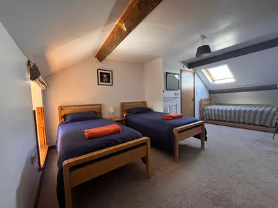 a bedroom with two beds in a room at Converted barn, perfect MTB break, Coed y Brenin in Trawsfynydd
