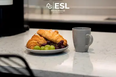 a plate of croissants and grapes and a cup of coffee at Dashing 2 Bedroom Duplex Apartment, Free Parking in Shrewsbury