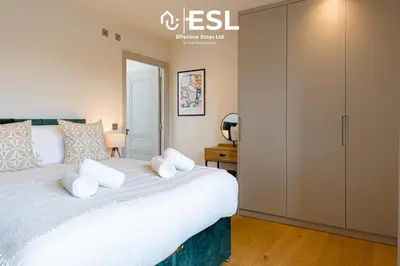 a bedroom with a large white bed with white pillows at Dashing 2 Bedroom Duplex Apartment, Free Parking in Shrewsbury