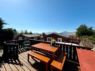 a wooden deck with a wooden table and benches at Shifty Chicken Shack in Trawsfynydd