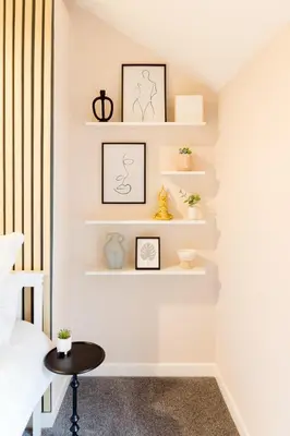 a room with white shelves and a table at Bridge Hideaway in Llangollen