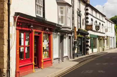 a street with red doors and windows on a building at Bridge Hideaway in Llangollen