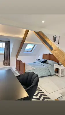 a bedroom with a bed and a table and a couch at Swn Y Don New Quay in New Quay