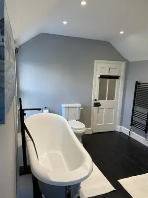 a bathroom with a white tub and a toilet at Swn Y Don New Quay in New Quay