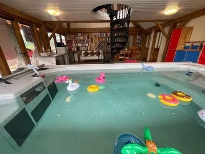 a swimming pool with toys in the water at Ty Nofio, Coity Bach in Brecon