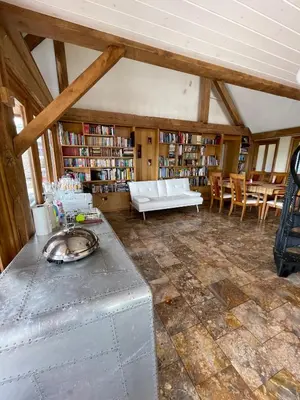 a living room with a white couch and bookshelves at Ty Nofio, Coity Bach in Brecon