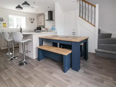 a kitchen with a blue island in a room at Cae Iocyn in Wrexham