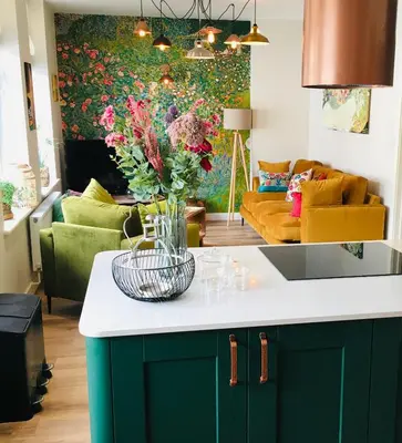 a kitchen with a vase of flowers on a counter at The Art Attic a Stylish Boutique Apartment in Builth Wells