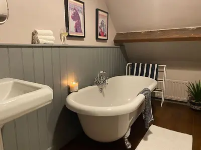 a bathroom with a bath tub and a sink at The Old Fire Station Ludlow in Ludlow