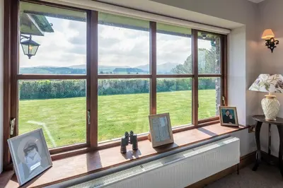 a window with a view of a green field at Beaconsview B&B in Brecon