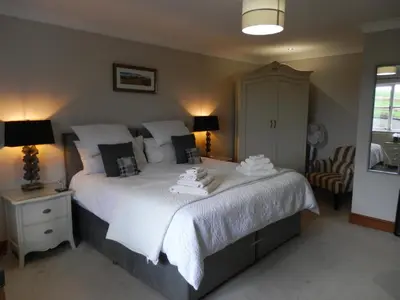 a bedroom with a large bed with towels on it at Beaconsview B&B in Brecon