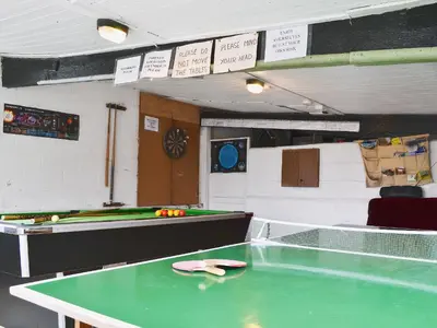 a ping pong table in a room with a pool table at Blackbird Cottage in Llanfair Caereinion
