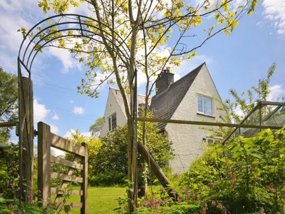 a garden with a fence and a tree at Bryn Araul in Rhydymain
