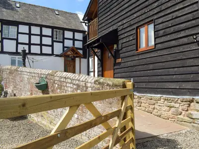 a wooden fence in front of a house at The Granary in Kingsland