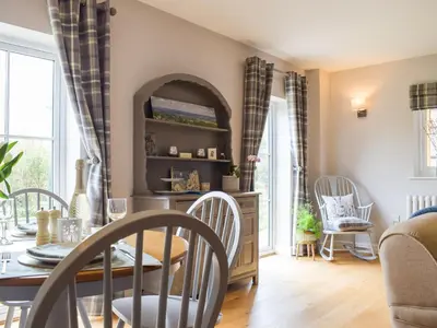 a dining room with a table and chairs at Little Bank Cottage in Lane to Richards Castle